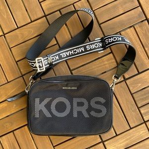 Michael Kors black Crossbody purse, Micheal Kors in white on strap.